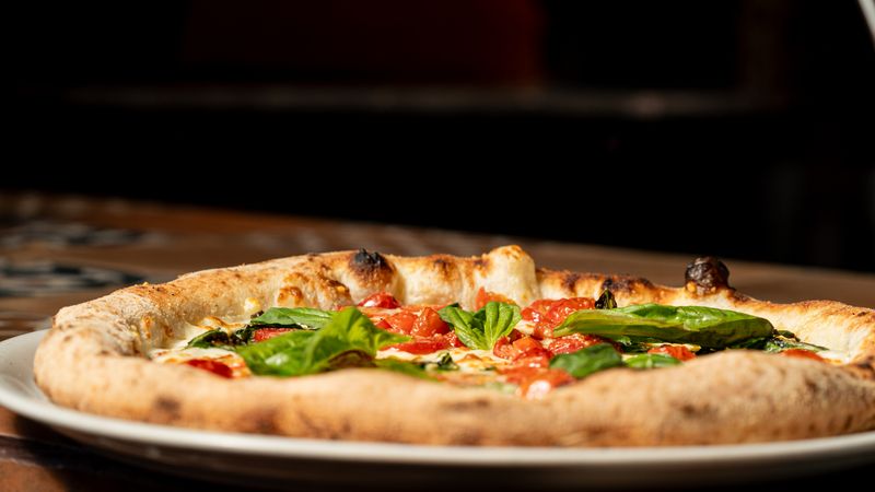 Classic Margherita pizza with fresh basil and mozzarella
